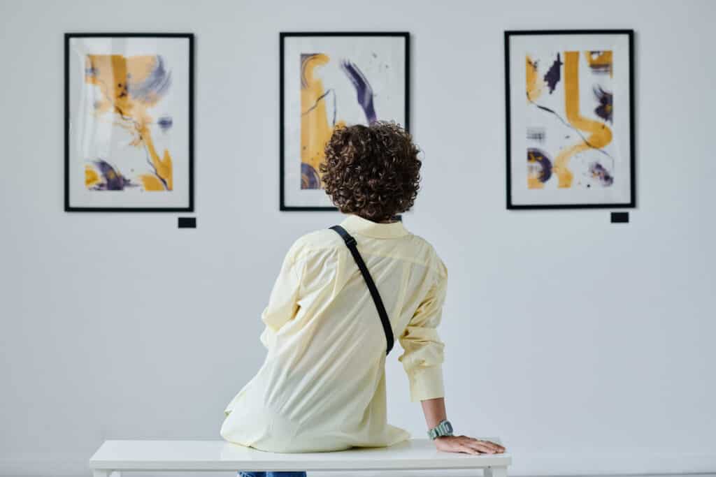 femme admirant un tableau dans une galerie d'art